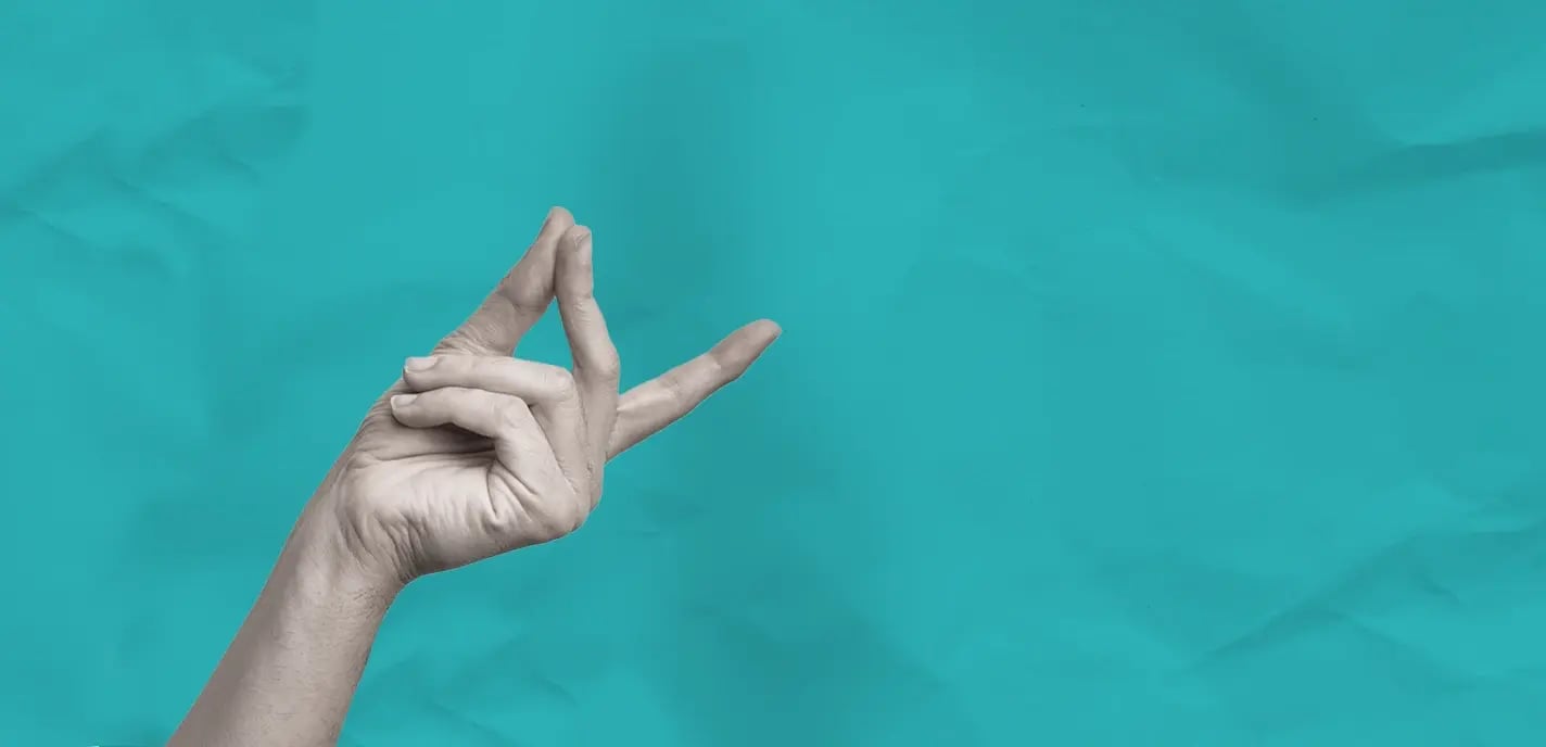 Isolated greyscale hand signifying ease against a teal background